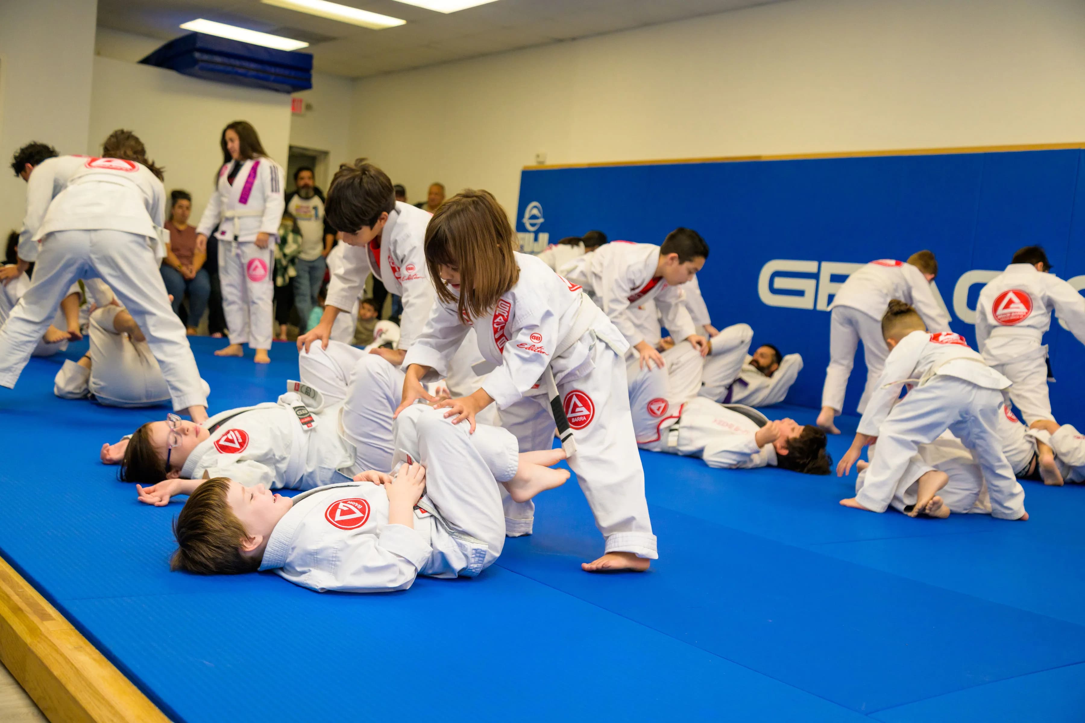 Kids practicing Brazilian Jiu-Jitsu on the mat at Gracie Barra Calallen in Corpus Christi